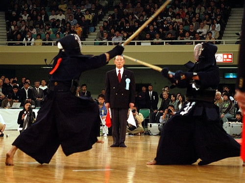 A view of kendo shiai with a referee.
