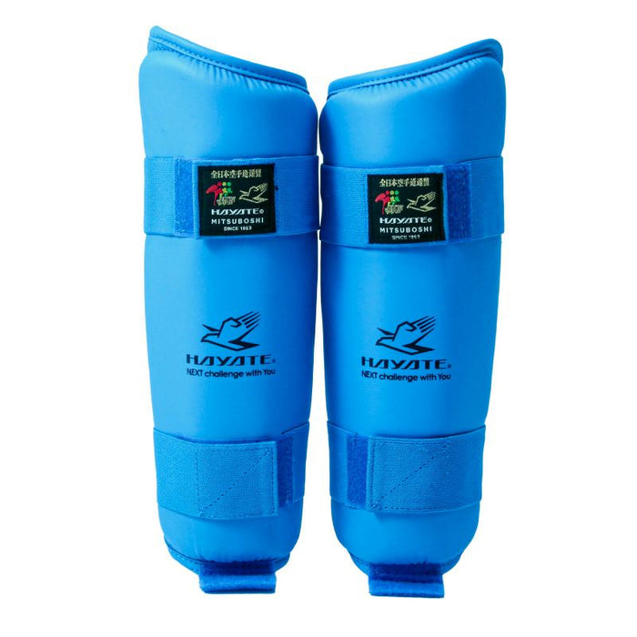 Pair of blue shin guards with Hayate branding on a white background