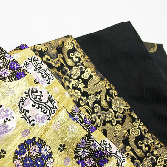 A selection of brocade fabrics seen enxt to each other.