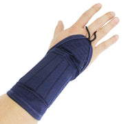 The wrist protector seen worn on the right hand and forearm.
