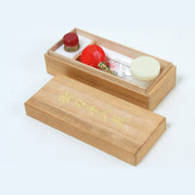The contents of the maintenance kit inside the paulownia box.