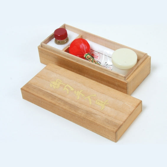 The contents of the maintenance kit inside the paulownia box.