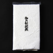 The wiping paper seen inside its packaging.