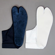 Comparison view of both the navy and white leather soles.