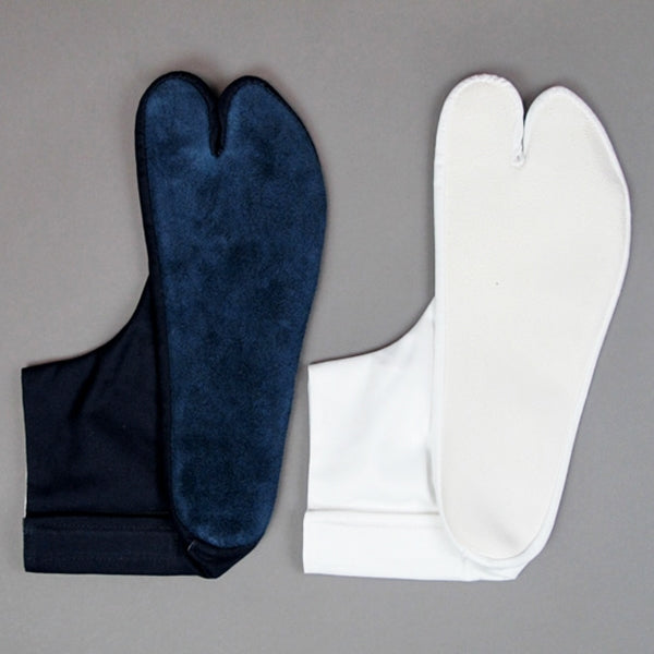 Comparison view of both the navy and white leather soles.
