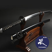 Full view of the iaito out of its saya, on a rack.