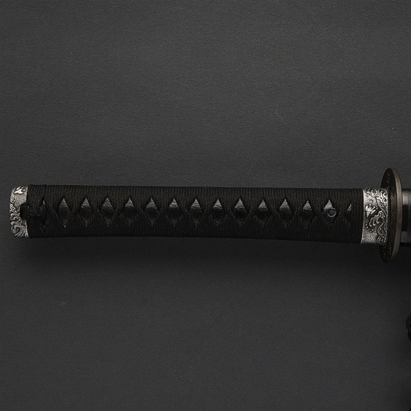Full view of the tsuka fittings with a nami chidori theme.