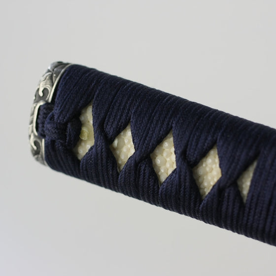 Close-up of the end of the tsuka and white same.