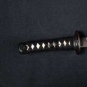 Close-up of the kodachi tsuka showing the sode and naginata themed menuki.
