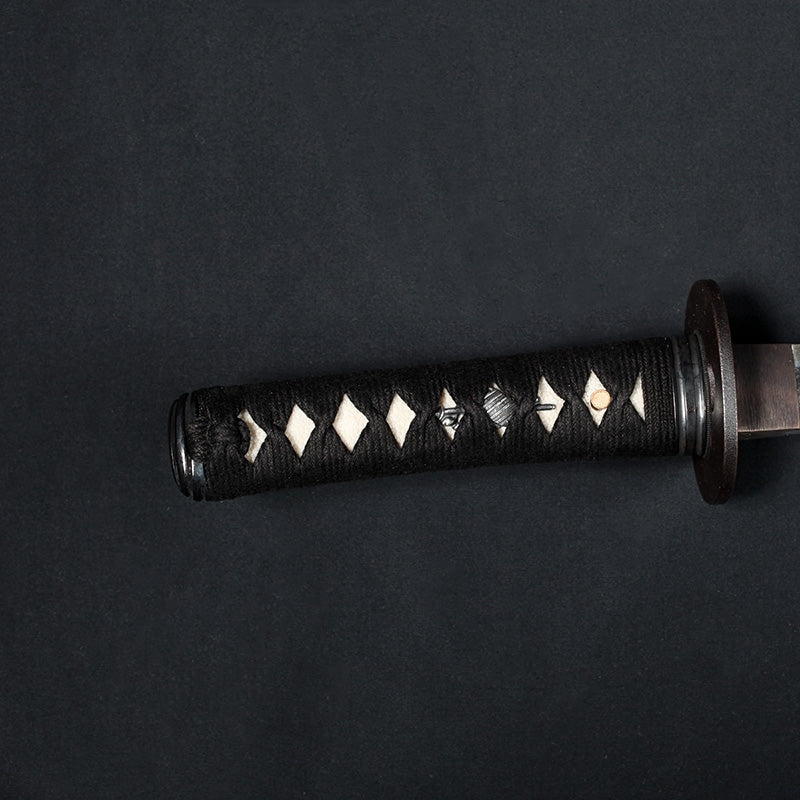 Close-up of the kodachi tsuka showing the sode and naginata themed menuki.