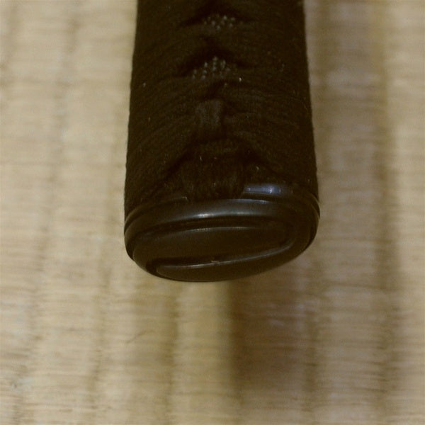 Close-up of the higo style black brass kashira fitting.