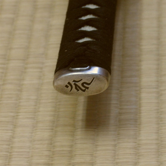 Close-up of the engraved bonji character on the kashira.