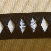 Silver-plated bonji menuki underneath the hinerimaki wrapping.