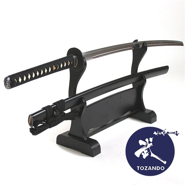 Full view of the iaito, out of the saya, on a rack.