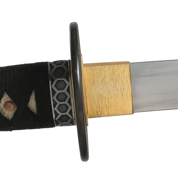 Close-up of the brass habaki and hive themed fuchi.