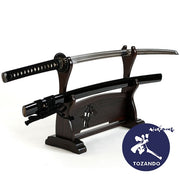 Full-view of the iaito outside of the saya and on a rack.