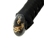 Close-up of the brass tsuka kashira with a dragon theme.