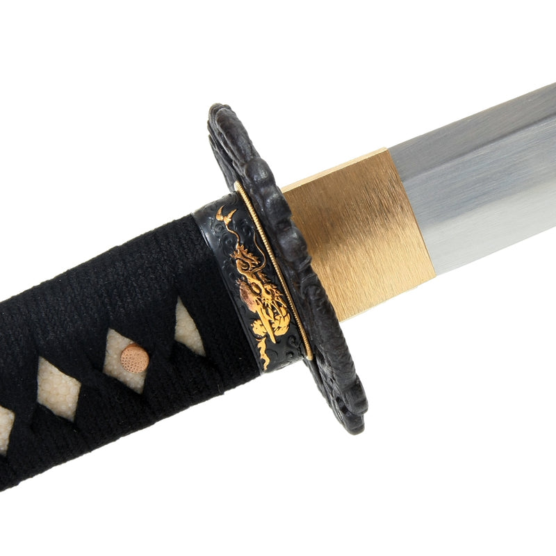 Side on view of the dragon themed fuchi and brass habaki.