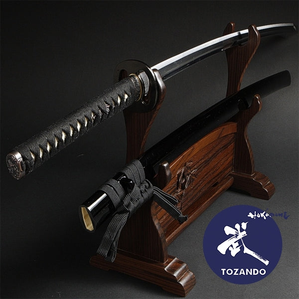 Full view of the iaito out of the saya, on a rack.