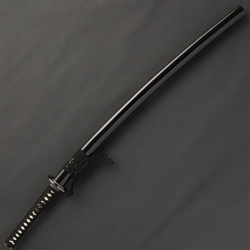 The iaito in its kuroro gloss black saya.