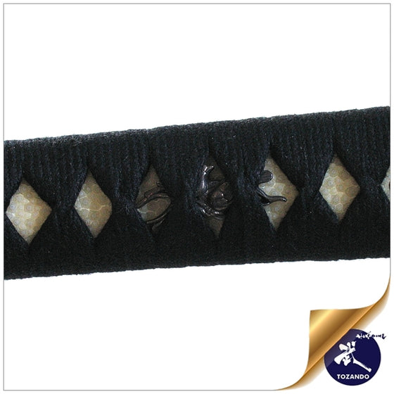 Close-up of the menuki ornaments beneath black cotton hinerimaki wrapping.