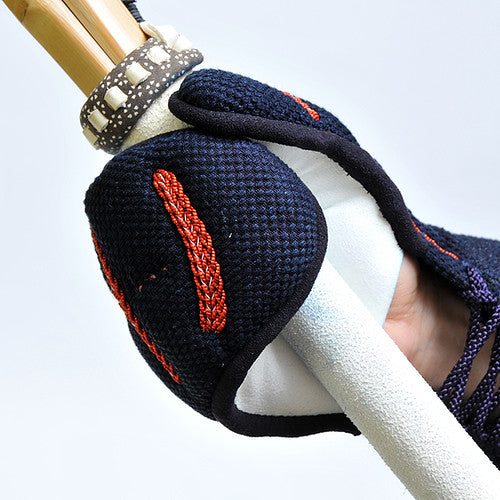Close-up of the kote holding a shinai.