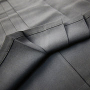 A view of the inner side of the lower hem and pleats.