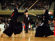 A view of kendo shiai with a referee.