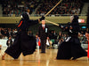 A view of kendo shiai with a referee.