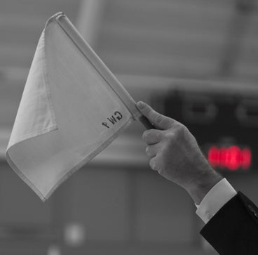 A white flag raised into the air signalling ippon has been scored by the white senshu.