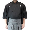 Front view of the tsumugi style dogi worn with striped hakama.