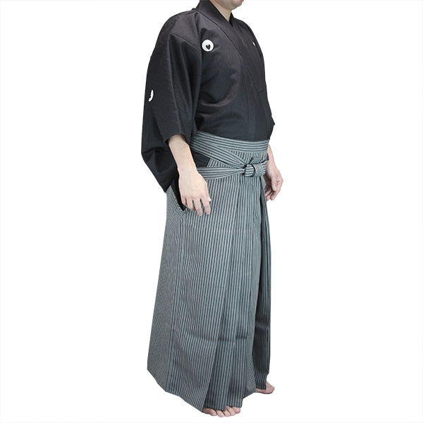 Side view of the nami stsumugi fabric dogi with striped hakama.