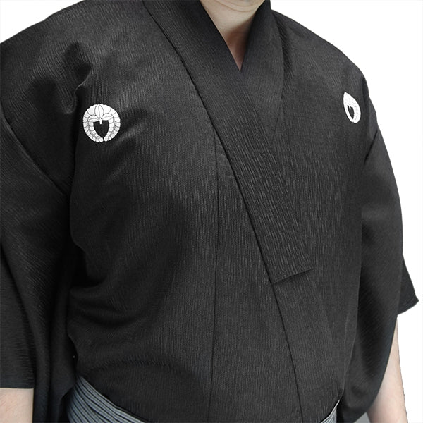 Close-up of the nami tsumugi dogi with customised kamon.