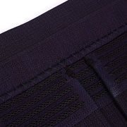 Decorative braids and cross-stitch of the obi seen close-up.