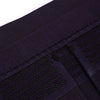 Decorative braids and cross-stitch of the obi seen close-up.